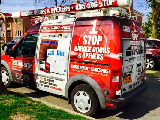 Side view of the 1 Stop Garage Doors & Openers service van with LiftMaster and Genie logos
